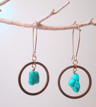 Turquoise suspended in brass rings
